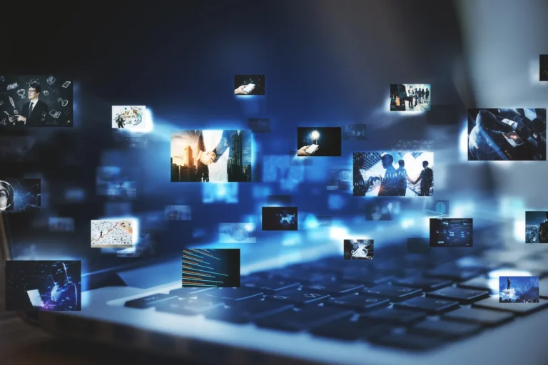 Kolaż miniatur materiałów wideo i grafik nad klawiaturą laptopa — tworzenie treści reklamowych